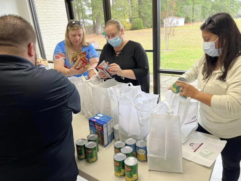 Volunteers organizing food bags at New Vision Ministries